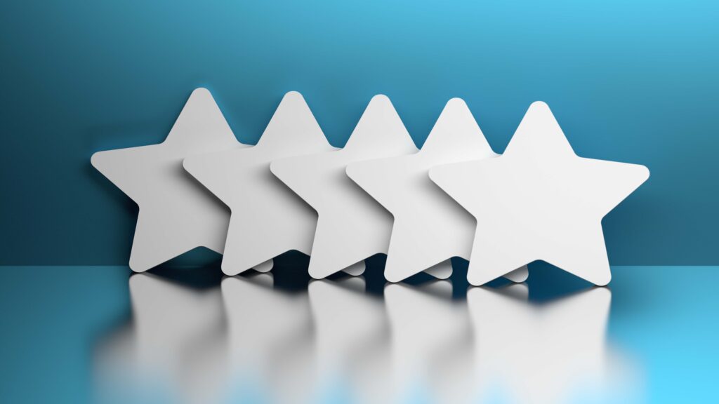Five white stars lined up on a reflective surface against a blue gradient background.